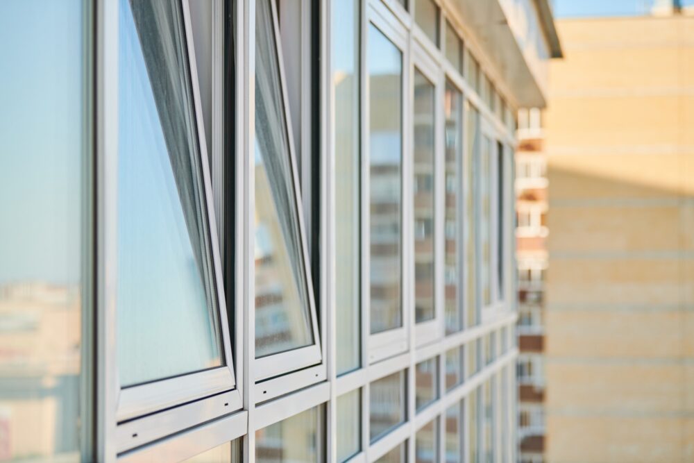 PVC windows on facade of skyscraper. Plastic double glazed windows. Building exterior.